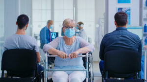 Senior woman with walker in hospital waiting area