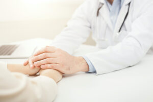 Closeup of patient and doctor hands