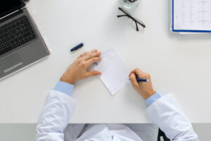 doctor hands with prescription at clinic