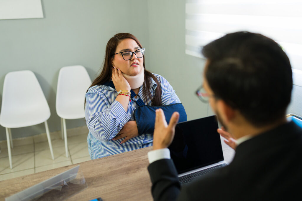 Injured woman discussing insurance claim with an agent