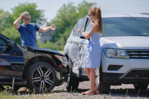 Two drivers having argument over who is guilty in car crash accident. Road safety and insurance concept.