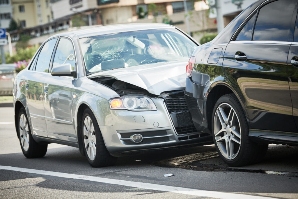 car crash accident. Car collision on city street. Two damaged automobiles