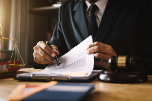justice and law concept.Male judge in a courtroom on wooden table and Counselor or Male lawyer working in office. Legal law, advice and justice concept.