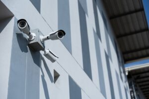 Security surveillance camera outside an office building, representing insurance company monitoring during a personal injury claim