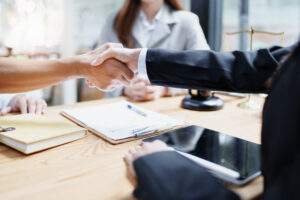Attorney reviewing mass tort lawsuit documents with a client
